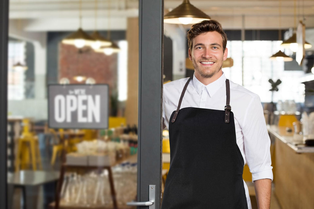 K0015XB | Canvas/Genuine Full-Grain Leather Work Apron. Bordeaux/Dark Brown. Antique Nickel Hardware. Dimensions: 70 x 90 x 0.5 cm. Packaging: Polybag